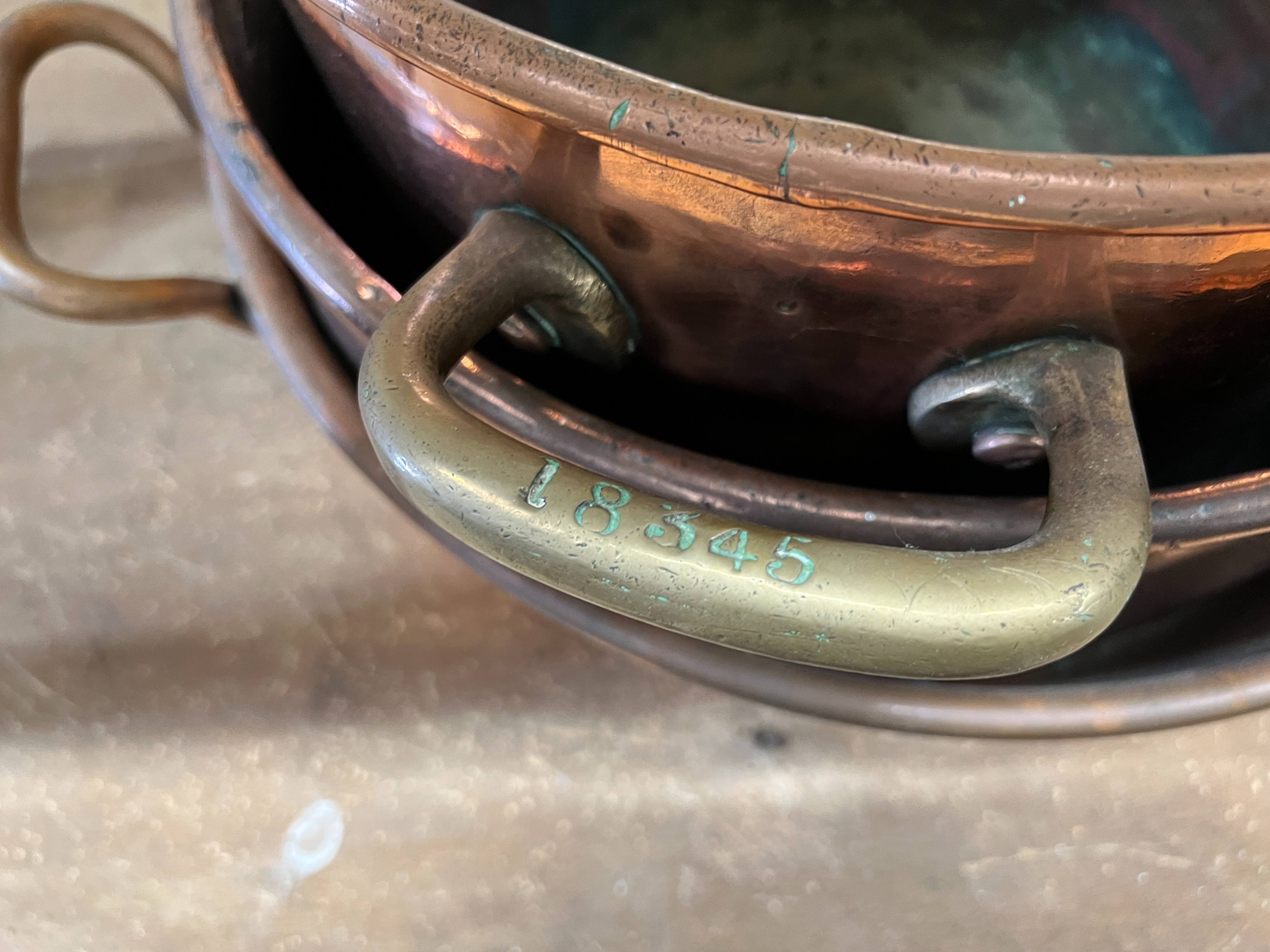 Three Victorian circular copper two handled preserve pans, largest diameter 43cm